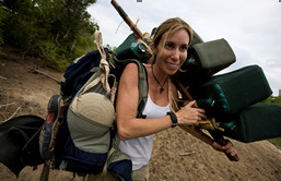 Mireya Mayor holding a camera in hiking gear