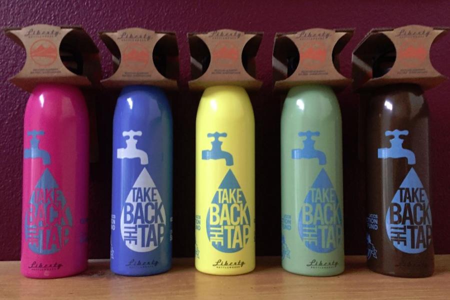 Colored water bottles: pink, blue, yellow, green, brown