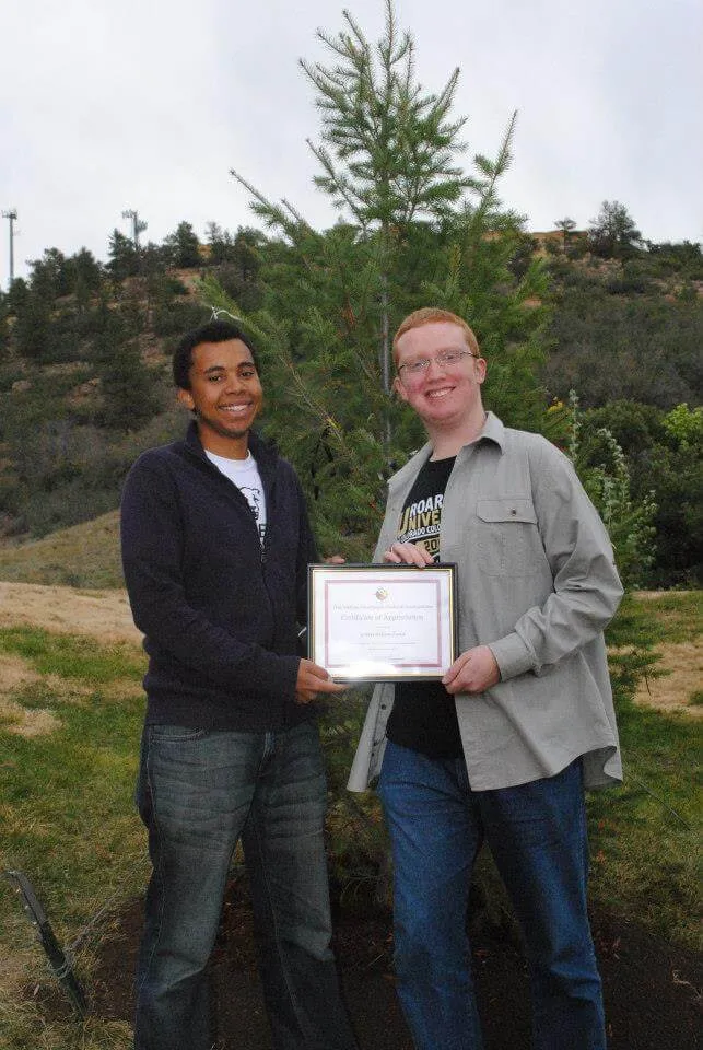 Two students standing in front of the tree of peace